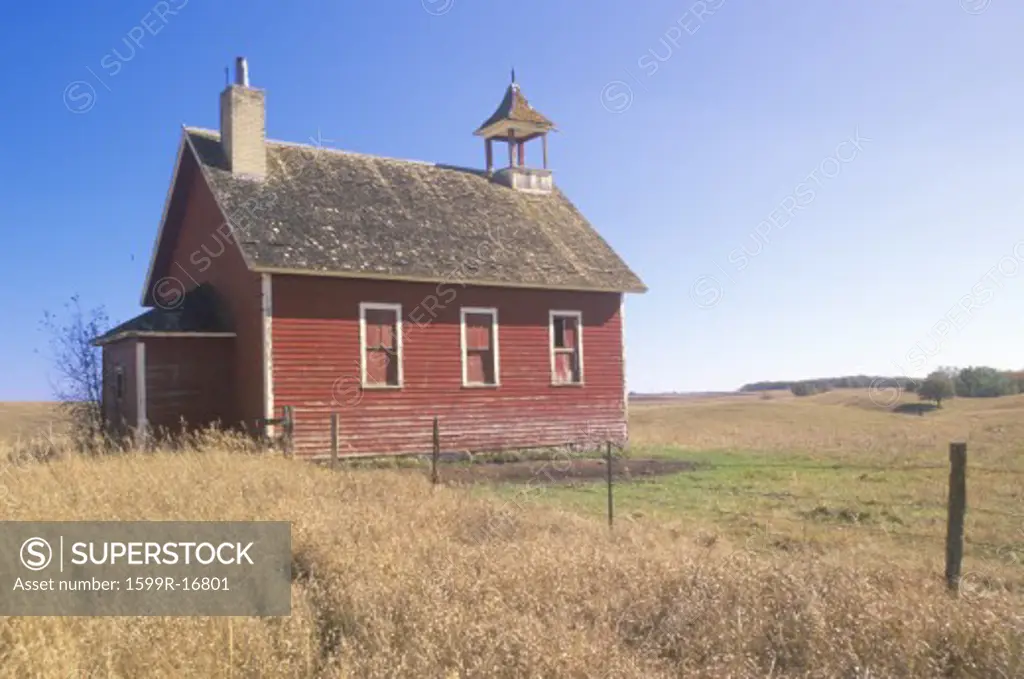 Old red schoolhouse on prairie, Battle Lake, MN
