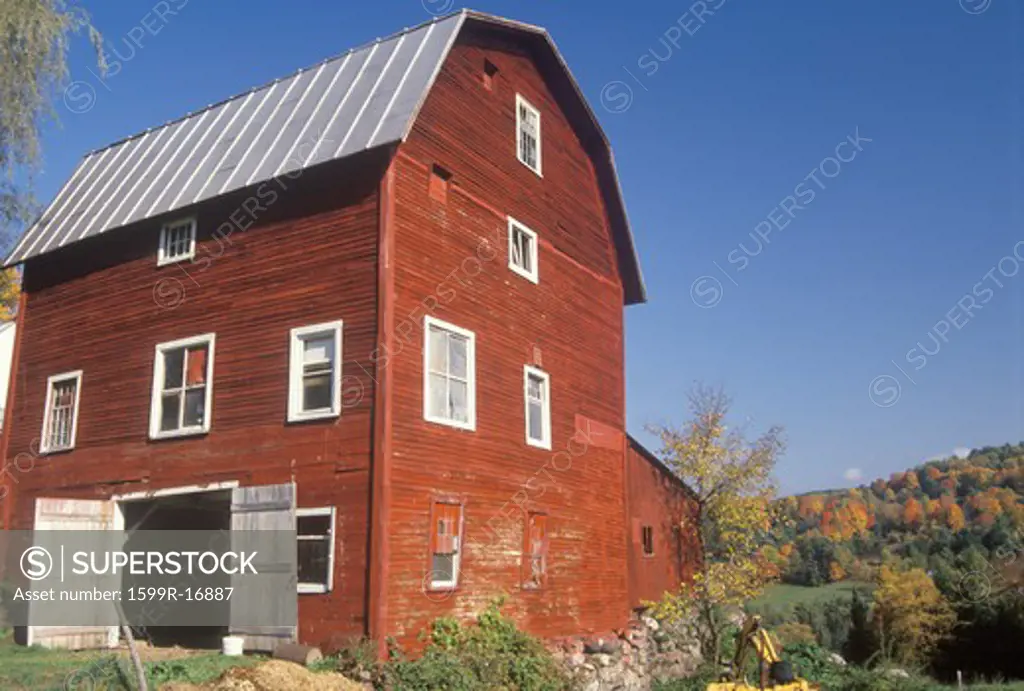 A three story red barn in autumn in VT