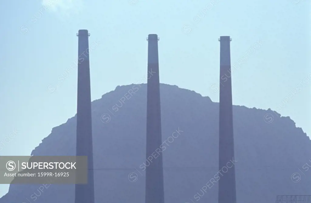 Three smoke stacks at a utility plant in Morro Bay, California