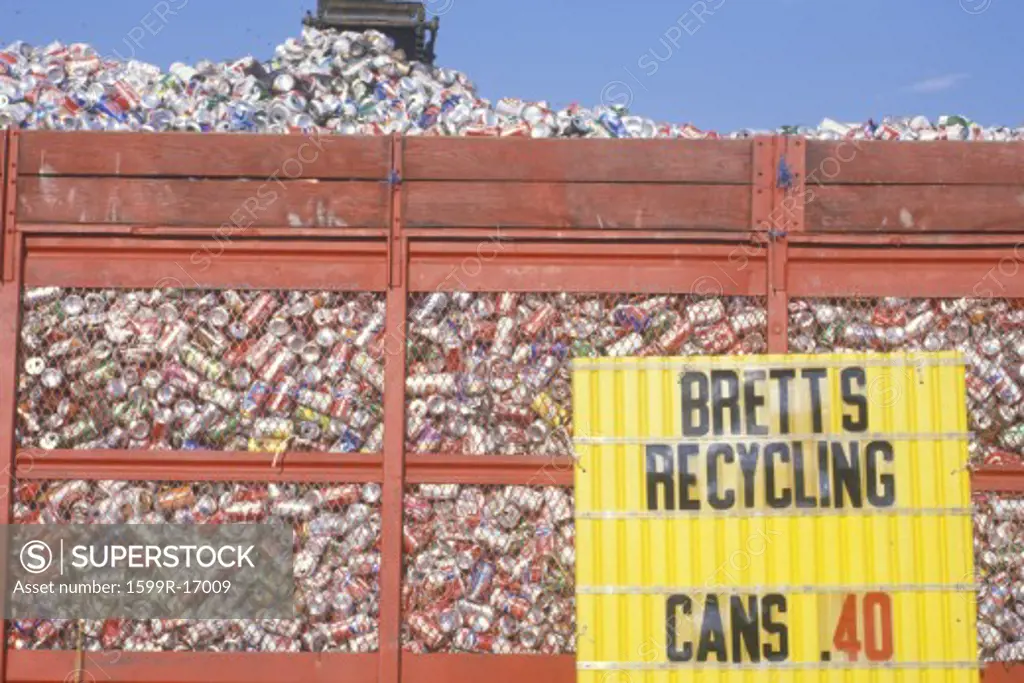 Aluminum cans collected to be recycled fill a large container