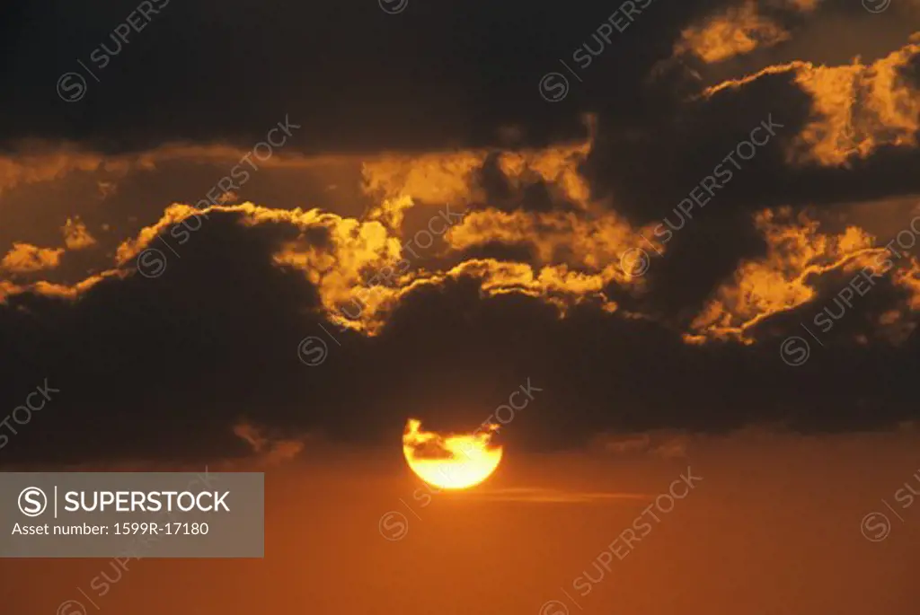 Sun Setting Through Clouds