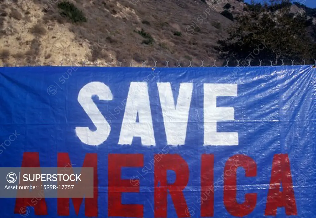 Sign on fence reads Save America