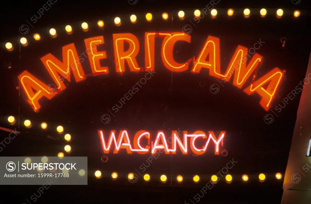 A neon sign that reads Americana, vacancy