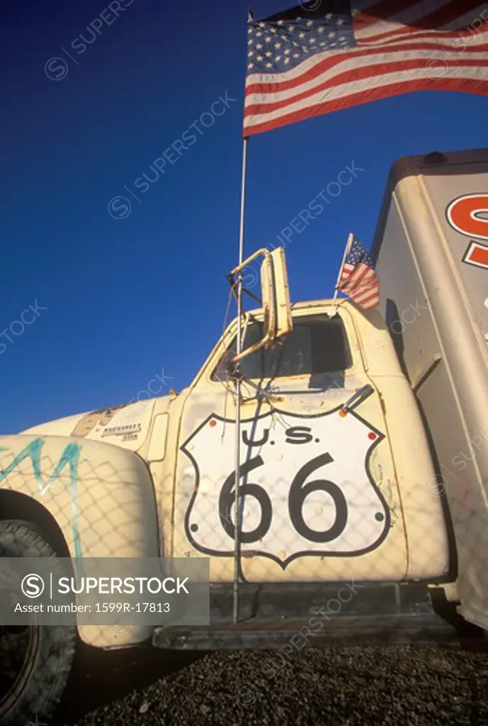 A truck with a route 66 sign painted on the door