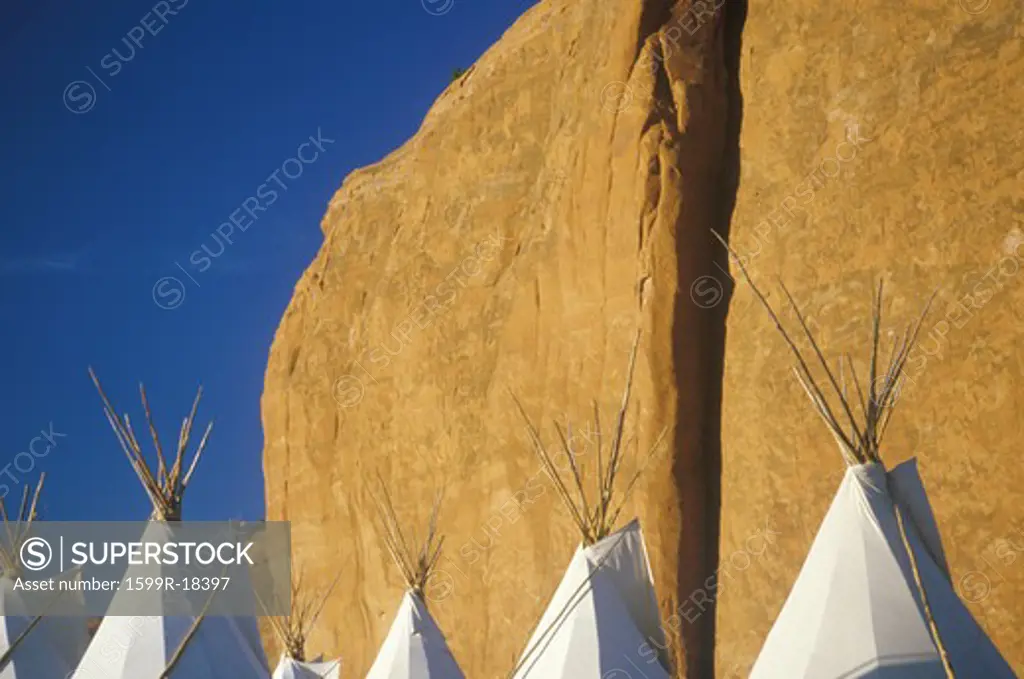 Navajo teepees against cliff, Gallup, NM