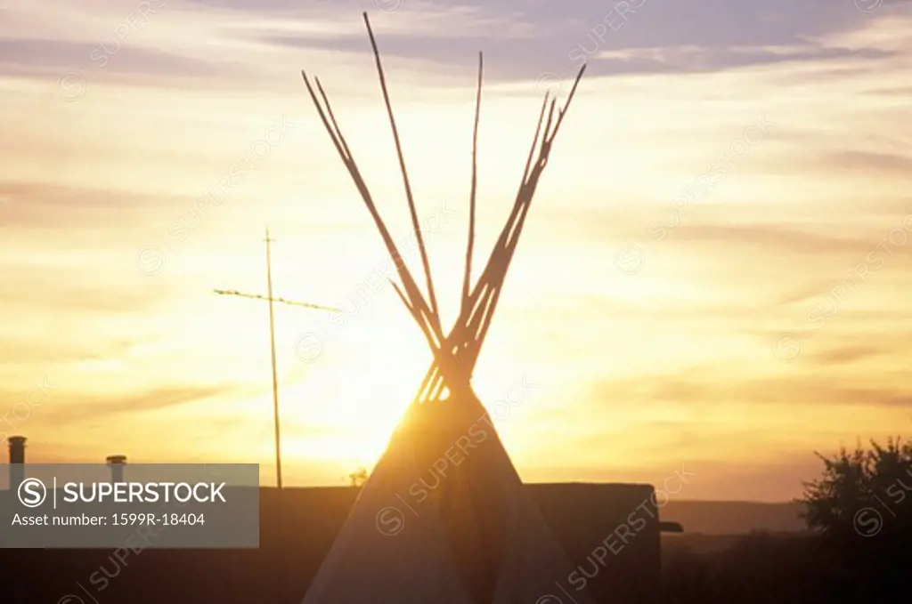 Teepee and cross silhouette on Indian reservation