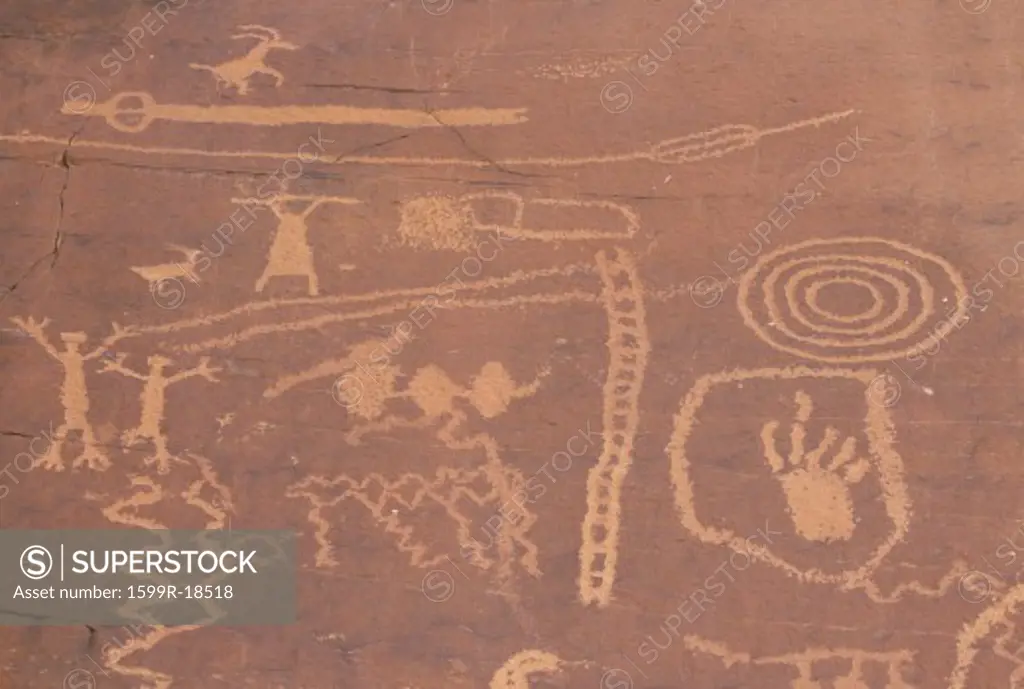 Petroglyphs of stick figures and spiral from Atlati Rock, NV