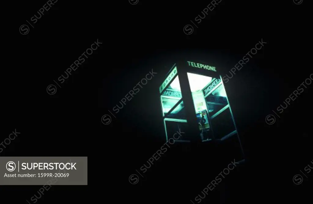Telephone booth at night with interior lights