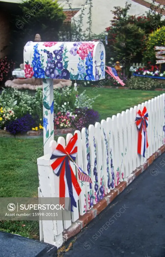 Patriotic decorations on residential mailbox and white picket fence, Cayucos, CA