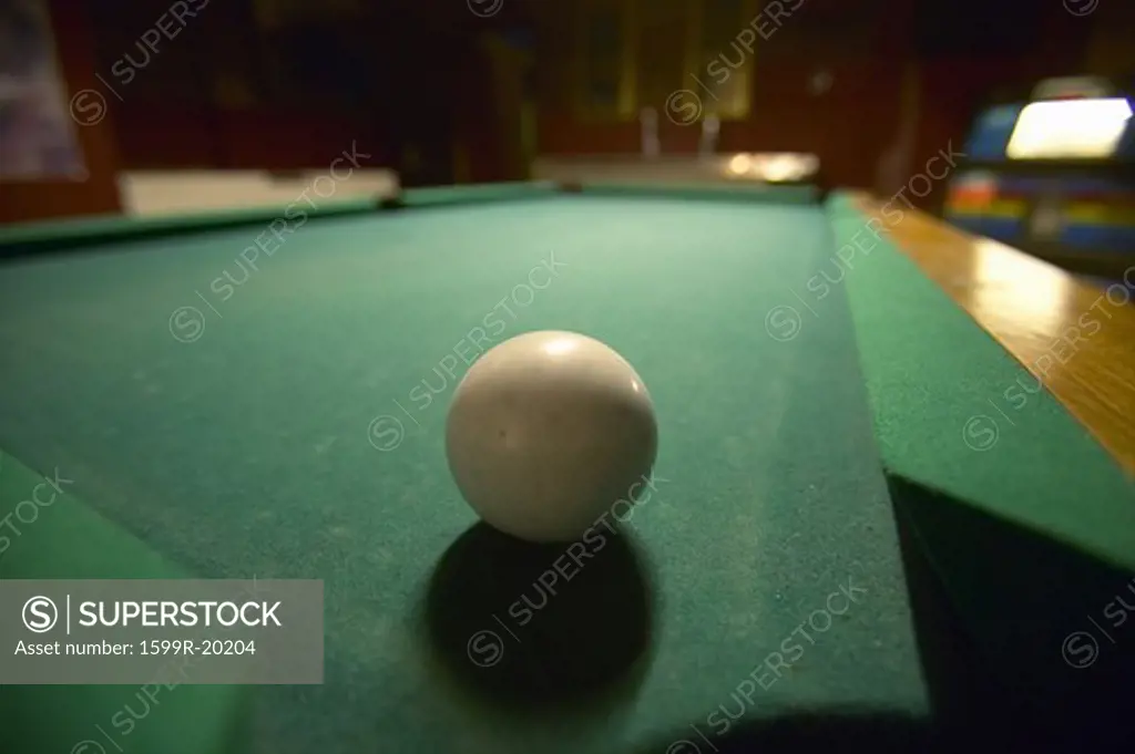 White pool ball lit by electric lights in a restaurant and bar in Shoshone, CA near Death Valley National Park