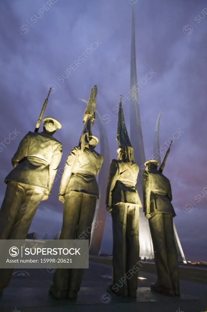 Dusk light behind bronze Honor Guard and three soaring spires of the Air Force Memorial, One Air Force Memorial Drive, Arlington, Virginia in Washington D.C. area