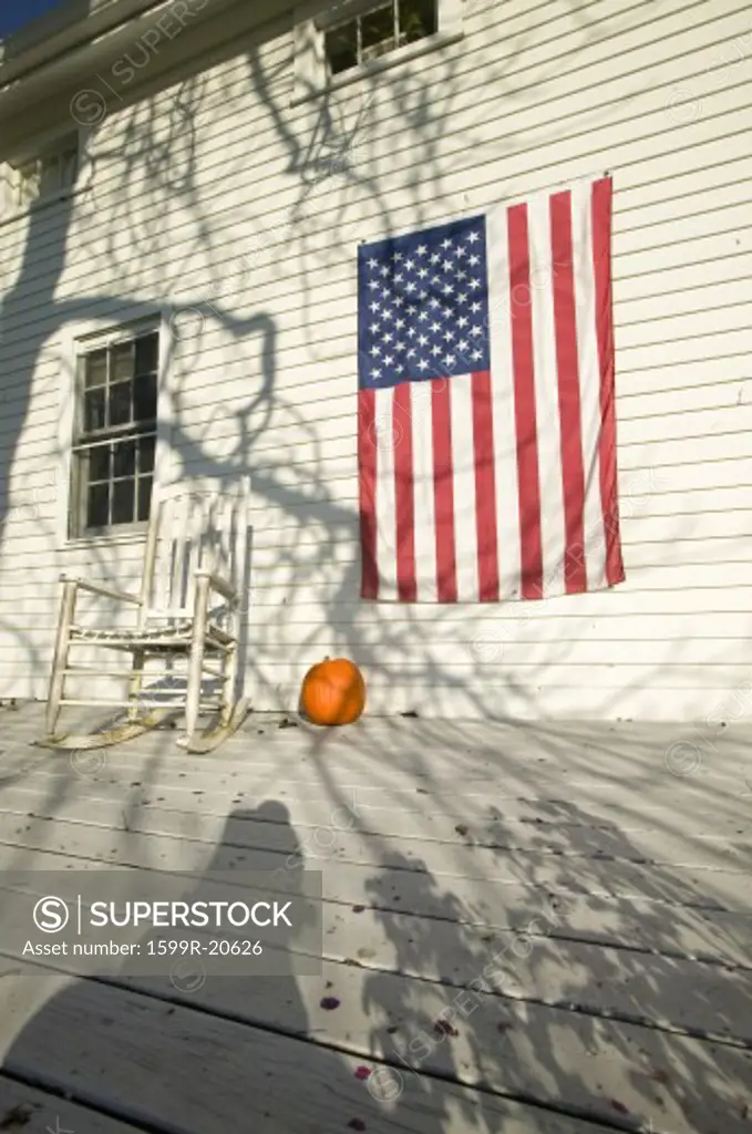 American flag, pumpkin and rocking chair on porch of home in Newport, Rhode Island