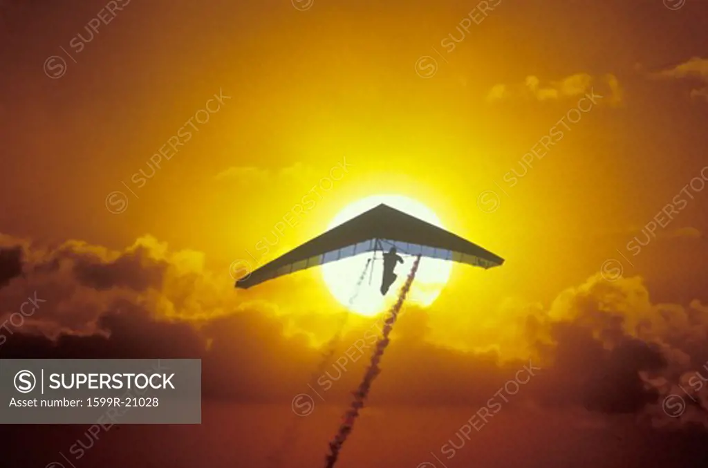 Solar Sailing Hang Gliding in sunset silhouette