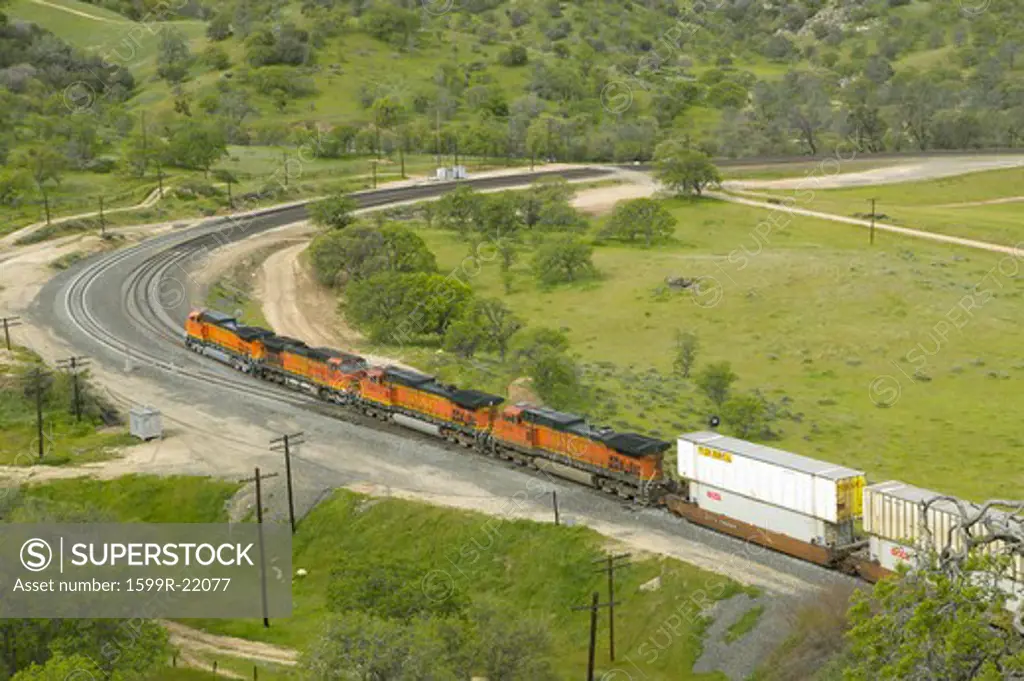 The Tehachapi Train Loop near Tehachapi California is the historic location of the Southern Pacific Railroad where freight trains gain 77 feet in elevation and show freight cars traveling in a giant loop