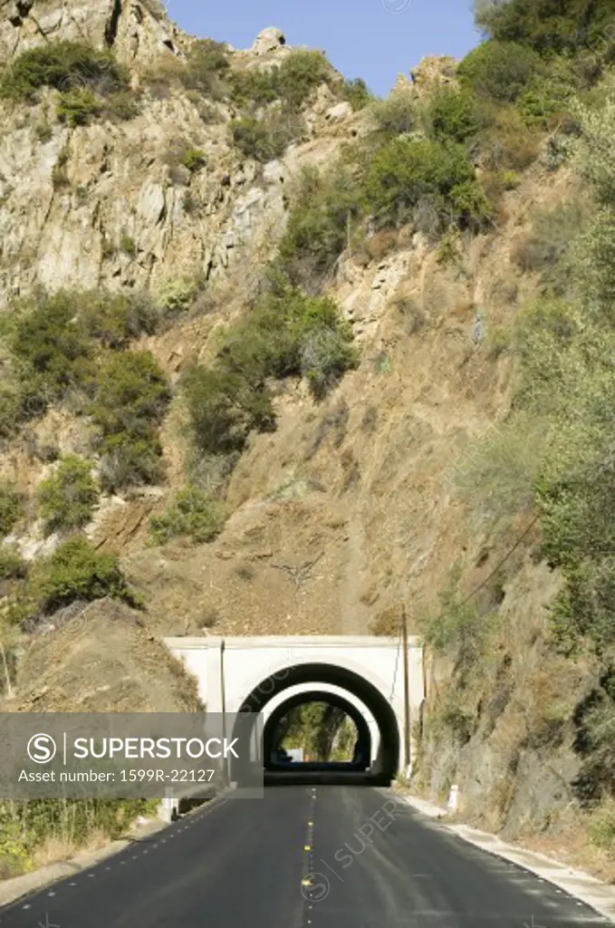Rural road leads to a tunnel through a mountain on highway 33 in Ojai, Ventura County California