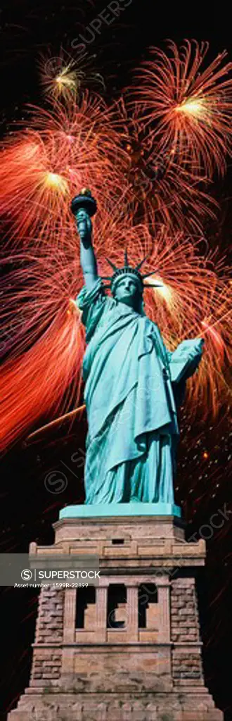 Composite image of the Statue of Liberty and pedestal against fireworks