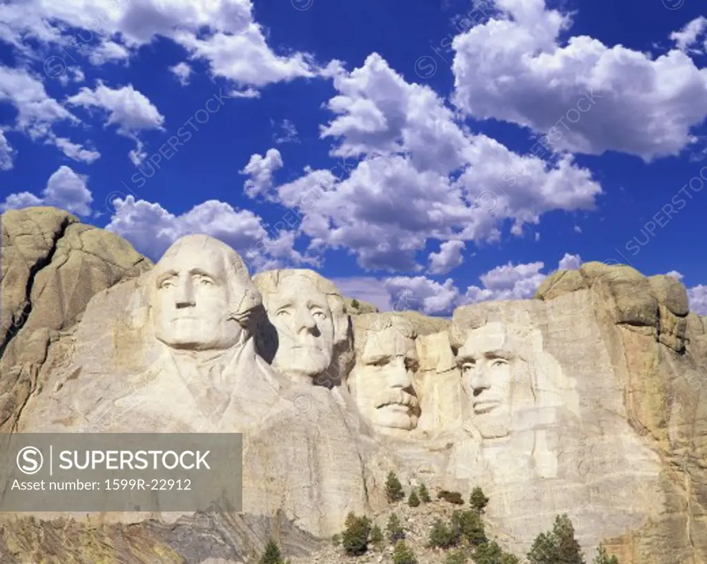 Composite image of Mount Rushmore and blue sky with white clouds