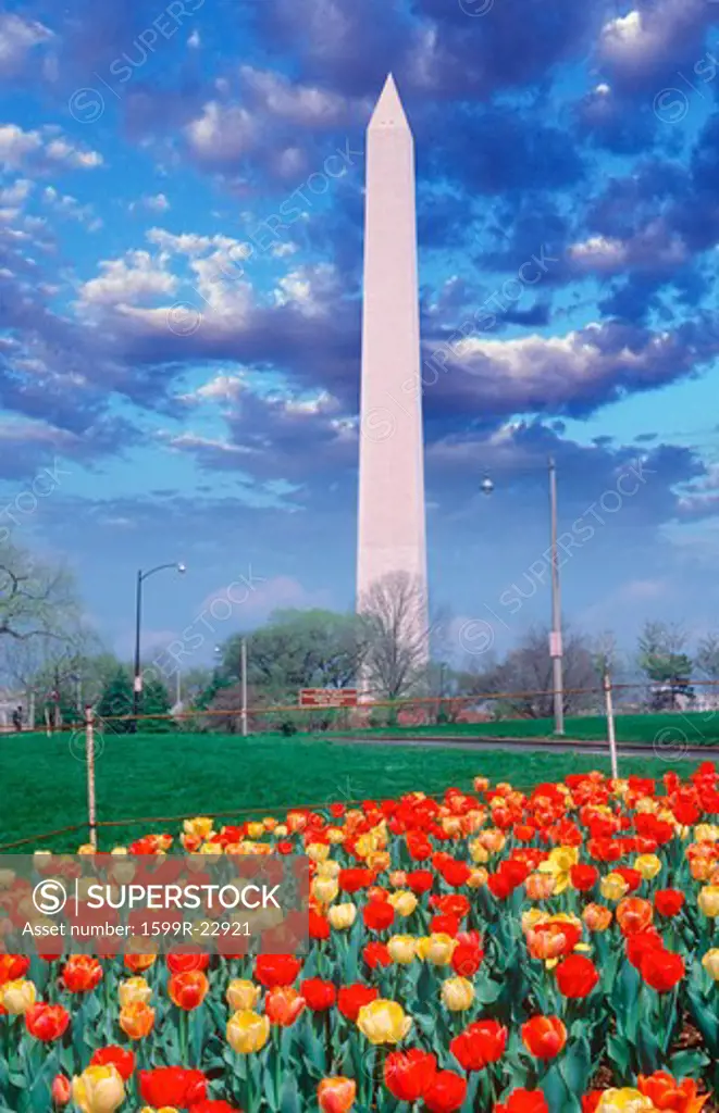 Composite image of Washington Monument and blue sky with white puffy clouds