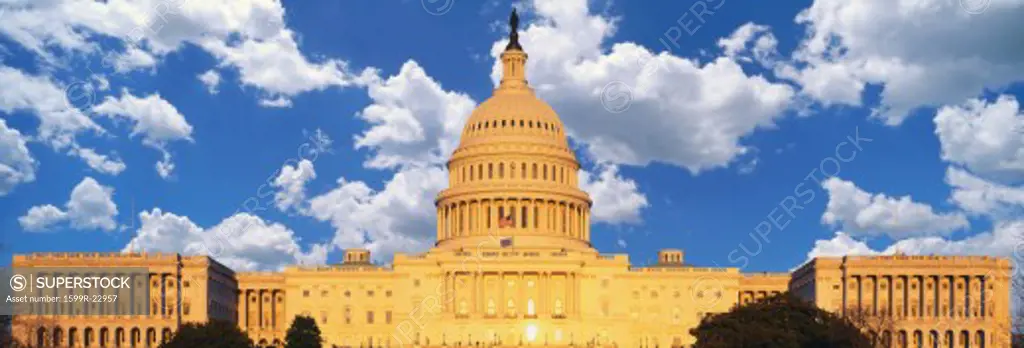 Composite image of the U.S. Capitol and blue sky with white puffy clouds
