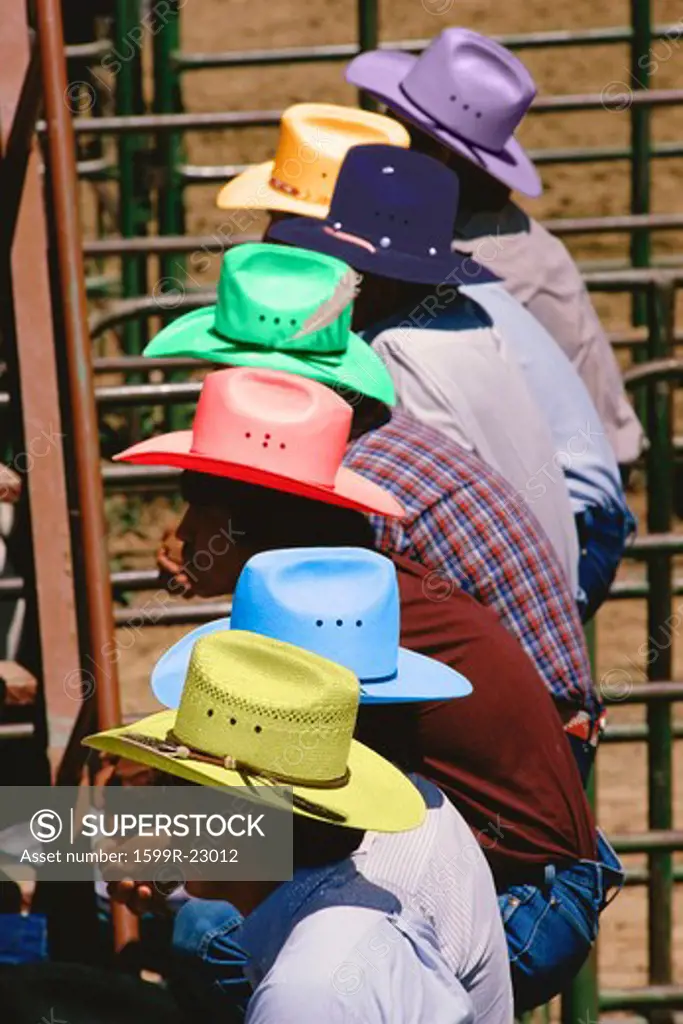 Digitally altered image of cowboys in colorful hats at a rodeo competition, Gallup, New Mexico