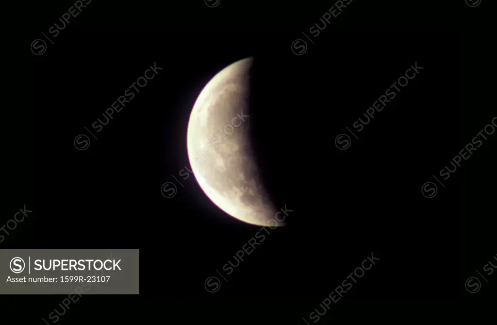 A First Quarter moon against a black starless sky