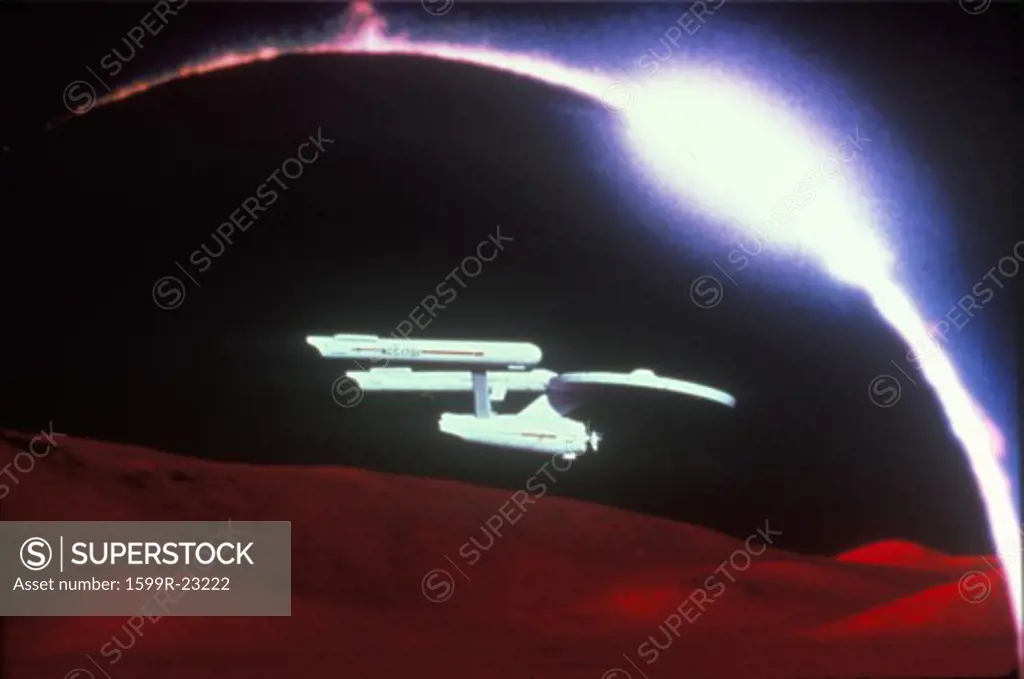 Star Trek's USS Enterprise soars over and alien landscape
