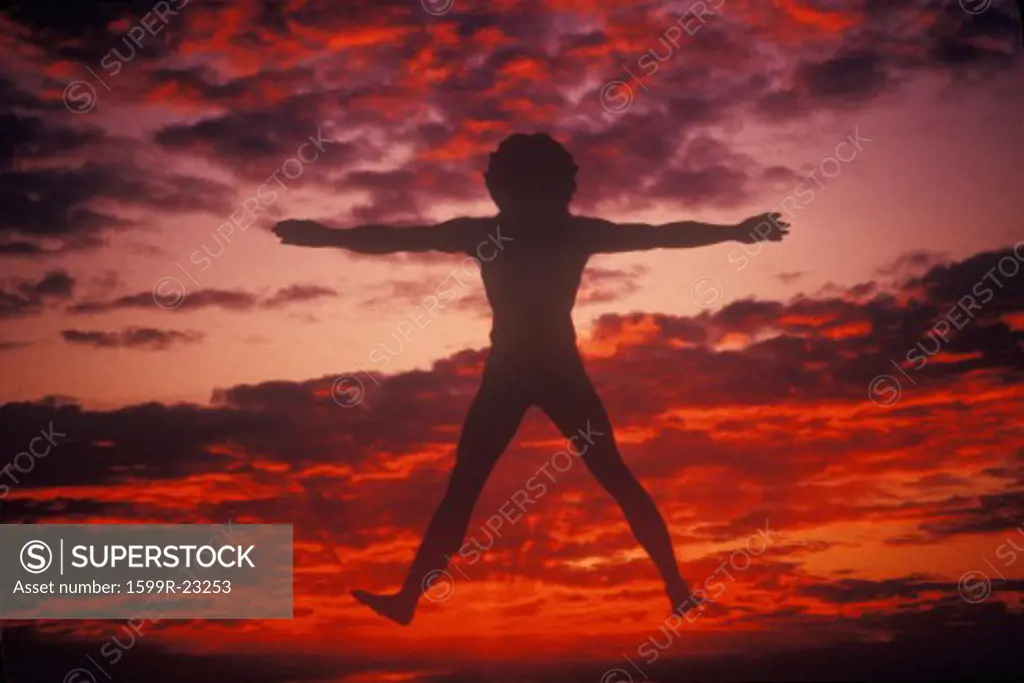 Sunset sky behind silhouette of New Age Man