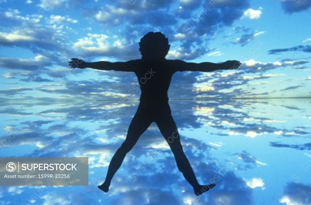 Clouds and blue sky behind silhouette of New Age Man