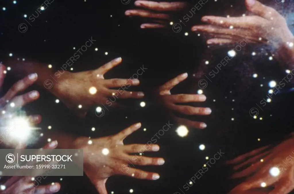 Special effects composite of many hands and starry sky