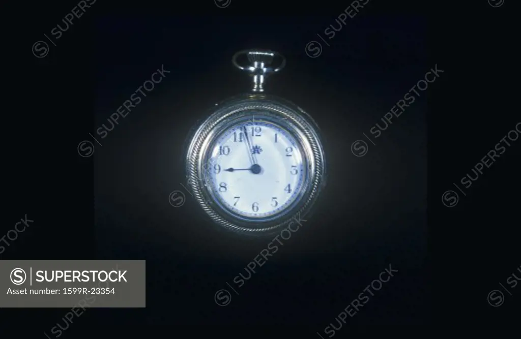 A pocketwatch against a black background