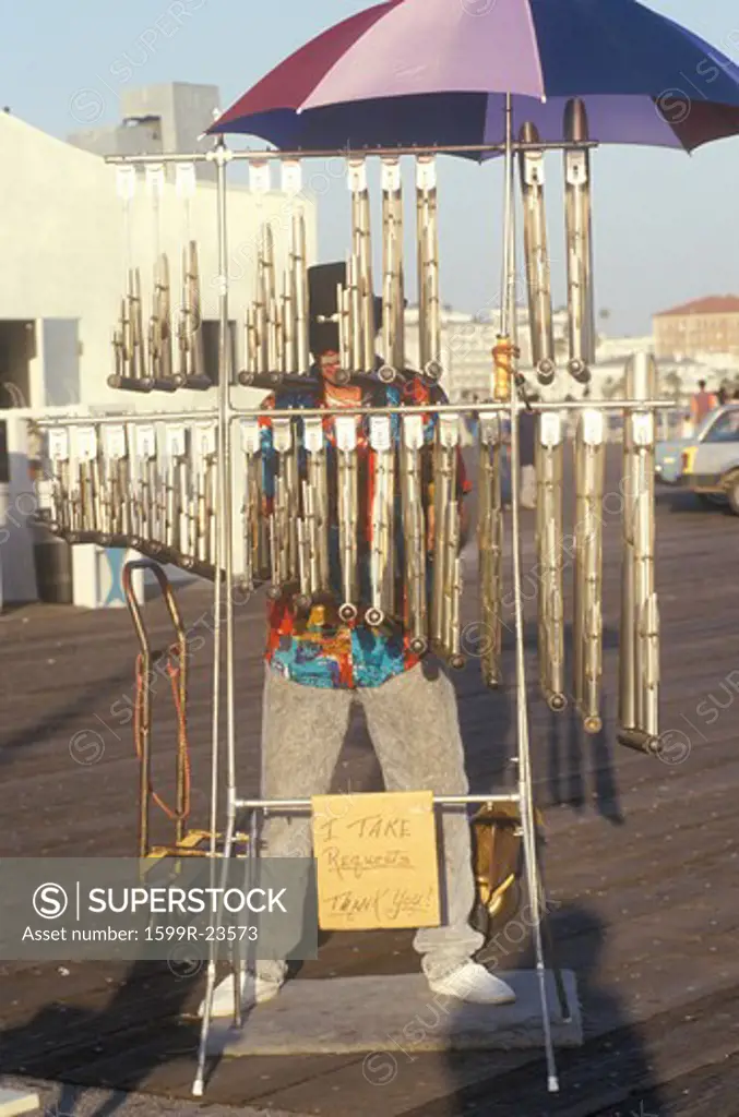 Street performer playing chimes on the Santa Monica Pier, Santa Monica, California