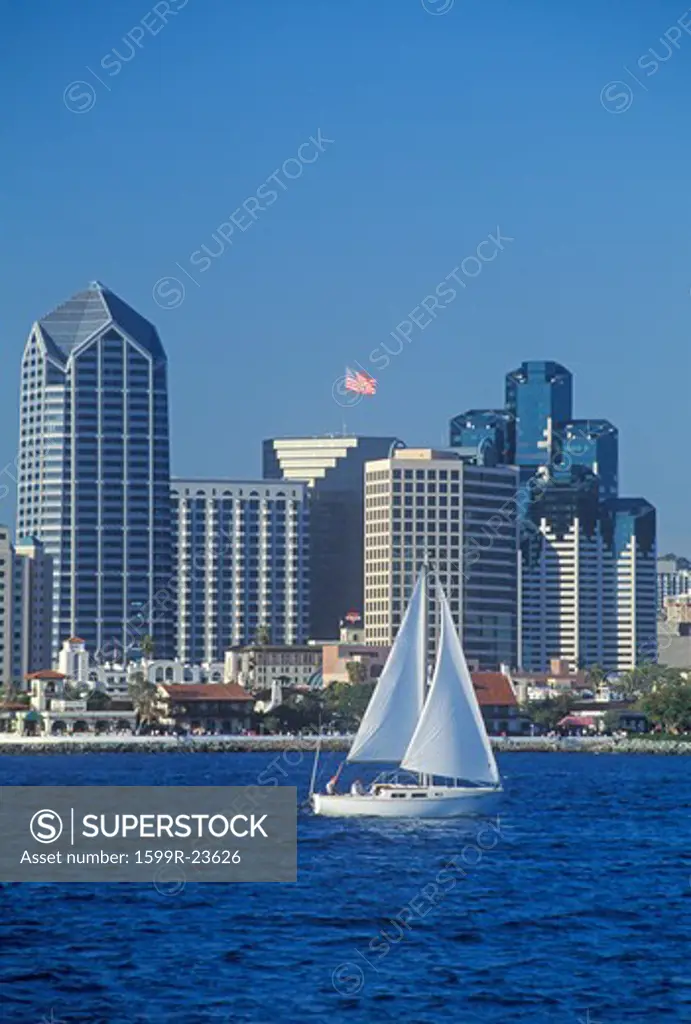 Sailboat sails in view of the San Diego skyline as seen from Coronado, San Diego, California