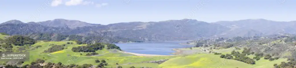 Elevated panoramic view of Lake Casitas and green fields in spring, shot from Oak View, near Ojai, California