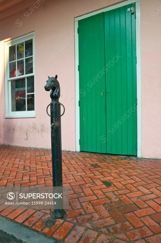 Old freshly painted doors and horse head hitching post in French Quarter near Bourbon Street in New Orleans, Louisiana