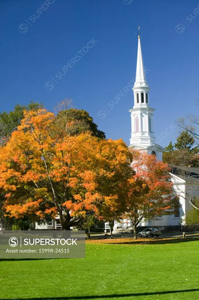 Autumn leaves on green common in front of Presbyterian Church in historical Lexington Massachusetts, New England