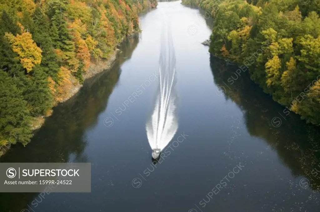 A boat navigates the Connecticut River through autumn color on the Mohawk Trail of western Massachusetts, New England