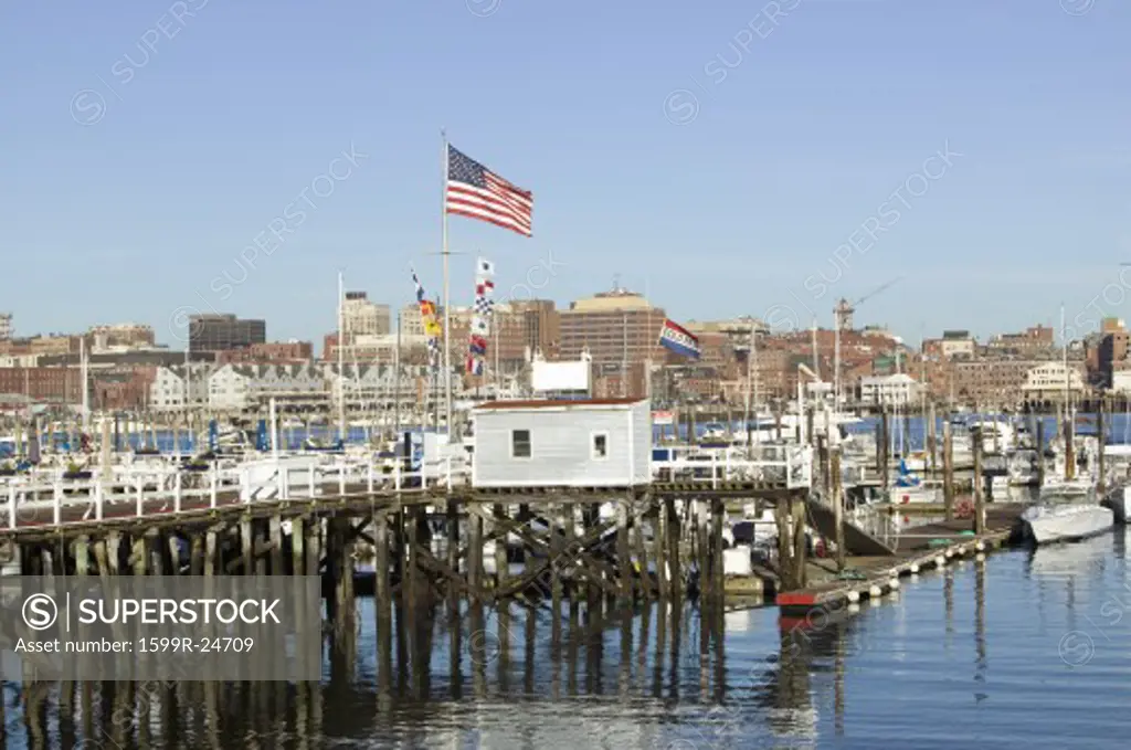 Large American flag flies in Portland Harbor with south Portland skyline, Portland, Maine