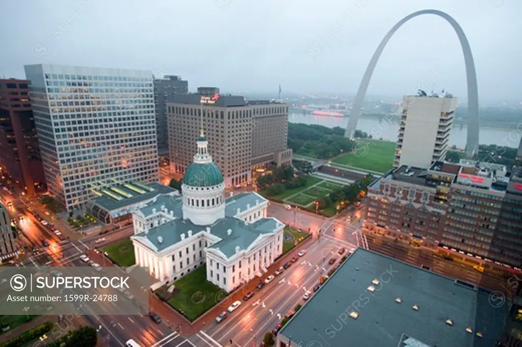In a misty rain an elevated view of Gateway Arch and the historical Old St. Louis Courthouse.  The Courthouse was constructed of brick in the Federal style of architecture in 1826 and was the site of the Dred Scott slave decision, St. Louis, Missouri