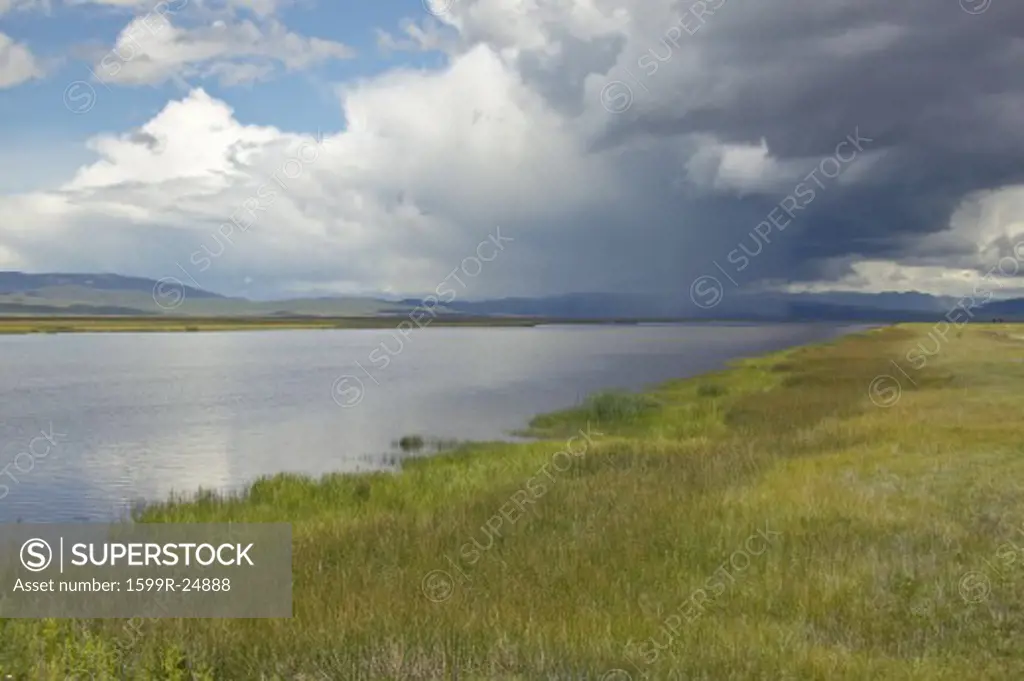 Storm clouds over grasslands and mountains at Red Rock Lake in Centennial Valley, near Lakeview, MT