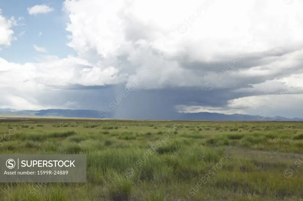 Storm clouds over grasslands and mountains at Red Rock Lake in Centennial Valley, near Lakeview, MT