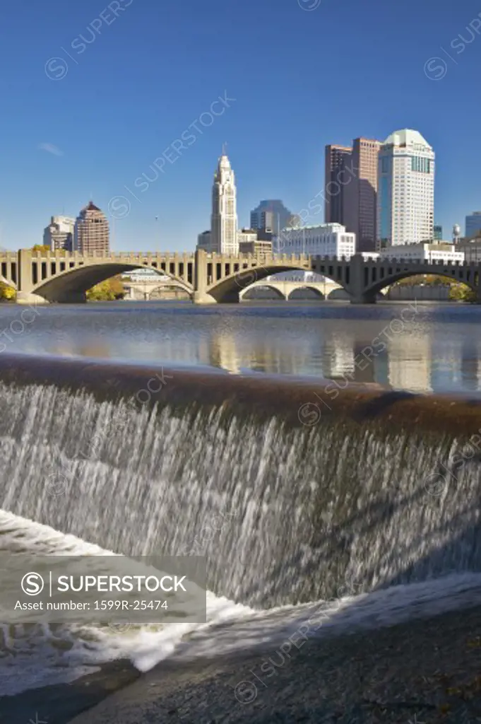 Scioto River with waterfall and Columbus Ohio skyline, with setting sunlight