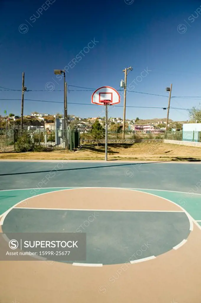 Basketball hoop and court in El Paso Texas looking toward Juarez, Mexico