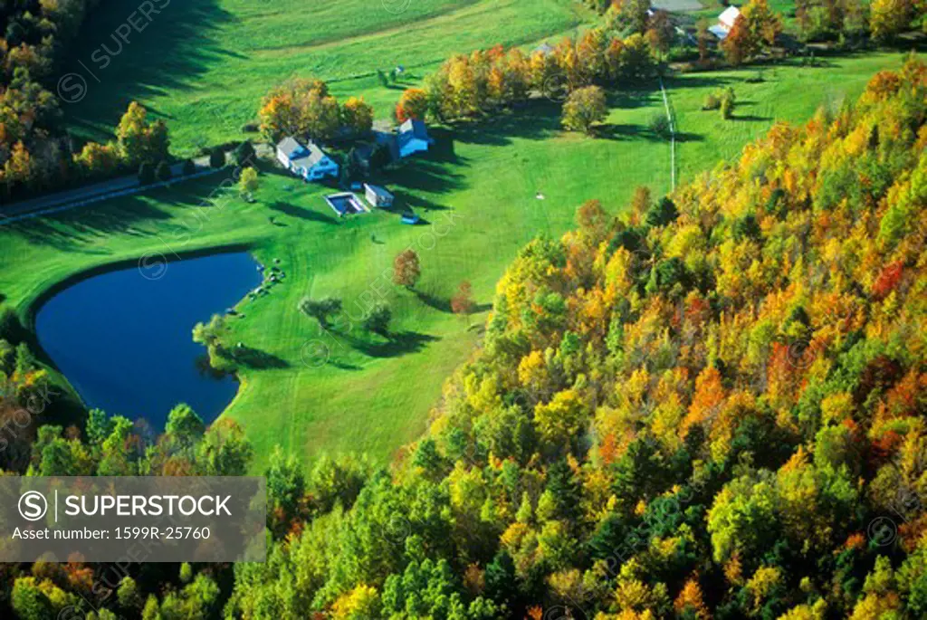 Aerial view of farm with pond near Stowe, VT in autumn on Scenic Route 100