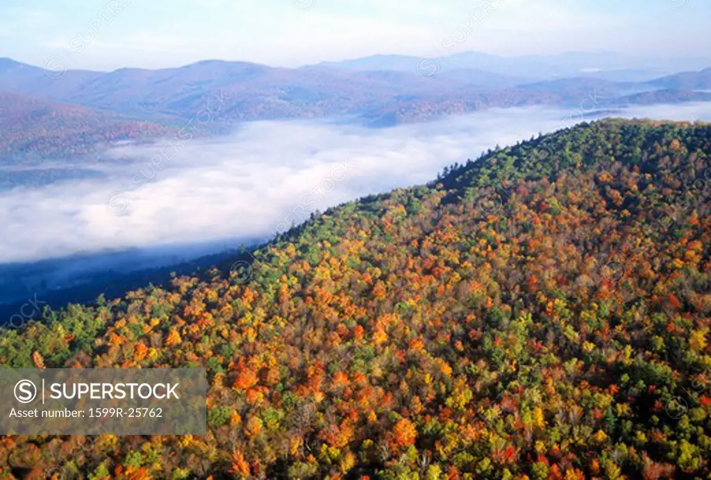 Aerial view of morning fog over mountains near Stowe, VT in autumn along Scenic Route 100