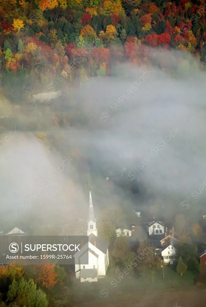 Aerial view of church steeple wreathed in morning fog in autumn, Waitsfield, VT