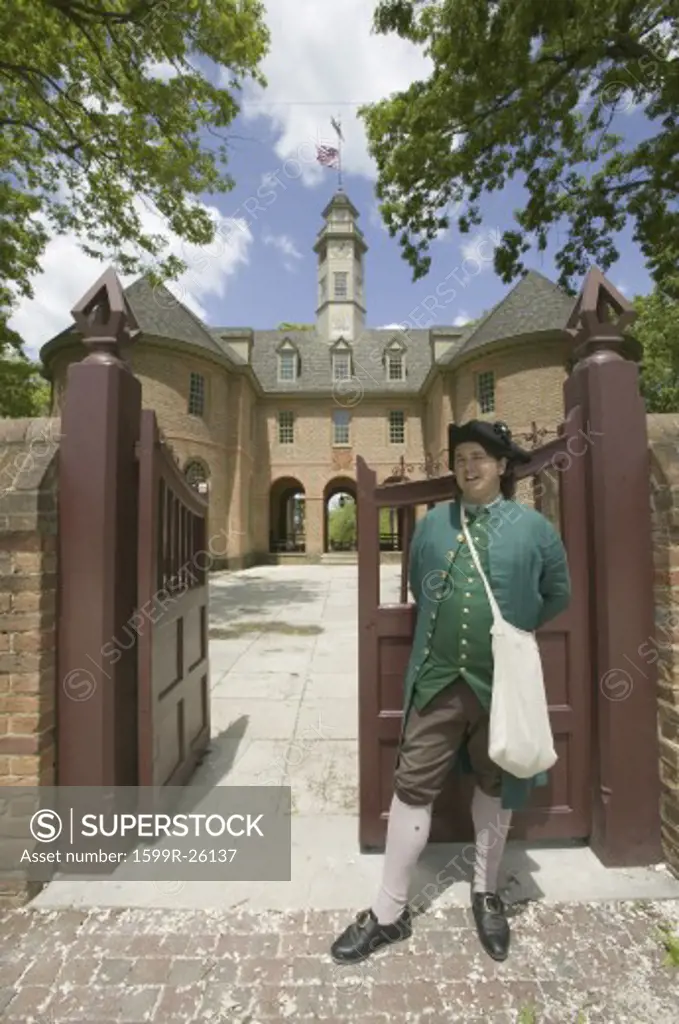 18th Century reenactor standing at front gate of the Capitol Building of Colonial Williamsburg, Virginia. In this building Patrick Henry, George Washington, George Mason, George Wythe, Richard Henry Lee, Jefferson, and others played their parts in the legislative wars that ended in revolution. The building that stands today is the third Capitol on the site.