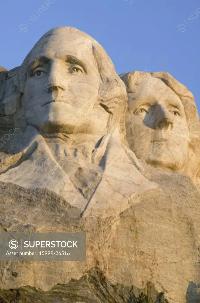 Sunrise on Presidents George Washington, Thomas Jefferson, Teddy Roosevelt and Abraham Lincoln at Mount Rushmore National Memorial, South Dakota