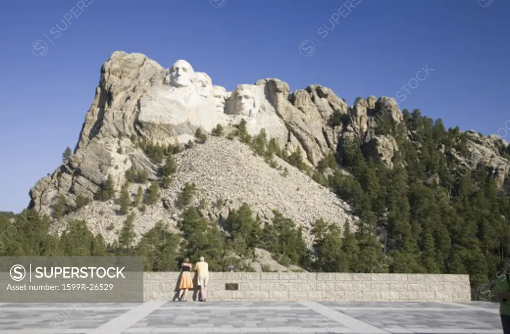 A man and woman at the Grand Terrace view of Mount Rushmore National Memorial, South Dakota