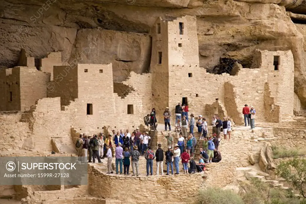 Tourists viewing kiva at Cliff Palace cliff dwelling Indian ruin, the largest in North America, Mesa Verde National Park, Southwestern Colorado