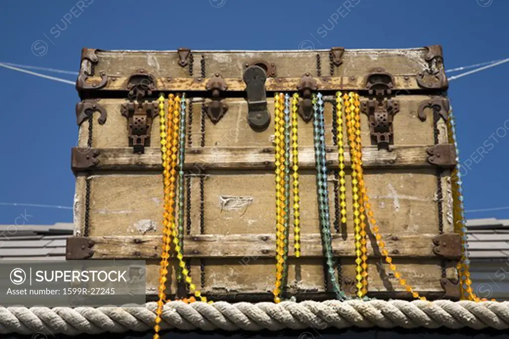 Treasure chest with fake necklaces hanging from trunk on pier of Santa Barbara, California